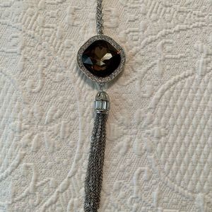 Long silver-tone necklace with rhinestones and large taupe stone.